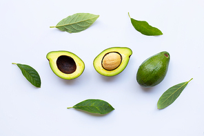 Avocado with green leaves on a white background.