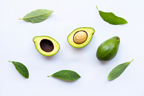 Avocado with green leaves on a white background.