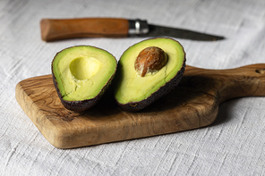 halves of avocado on a board