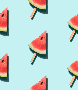 watermelon popsicle seamless pattern. watermelon slice on wooden popsicle stick over blue background. top view or flat lay. isometric view