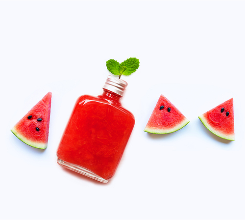 Bottle of healthy watermelon juice with slice and mint leaves isolated on white.