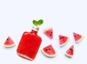 Bottle of healthy watermelon juice with slice and mint leaves isolated on white background.