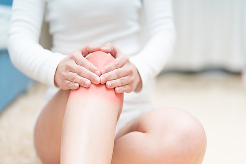 knee pain injury women sitting and touch her knee painful, healthcare and medicine concept