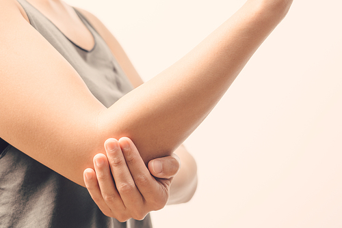 closeup women elbow pain/injury with white backgrounds, healthcare and medical concept