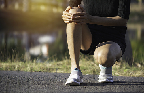 The female clings to a bad leg. The pain in her leg. Healthcare and painful concept.