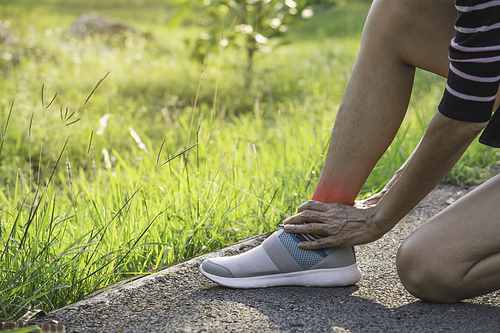 The female clings to a bad leg. The pain in her leg. Health and painful concept.