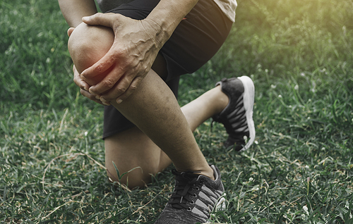 A man clings to a bad leg. The pain in her leg. Health and painful concept.