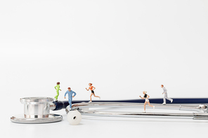 Miniature people running on stethoscope , Sport and healthy concept