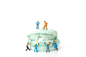 Miniature people : Worker team repairing a tooth ,Healthcare and medical concept