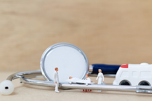 Miniature people : Doctor with nurse carry the patient on a stretcher. Healthcare  concept.
