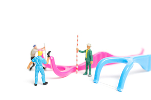 Miniature people : The team work on Dental floss isolate on white background , Dental clinic concept