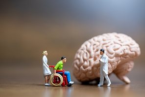Miniature people, Surgeon spoke with patient about brain injuries. Medical healthcare and surgical doctor service concept.