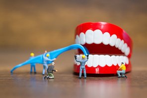 Miniature people : Worker team repairing a tooth ,Healthcare and medical concept