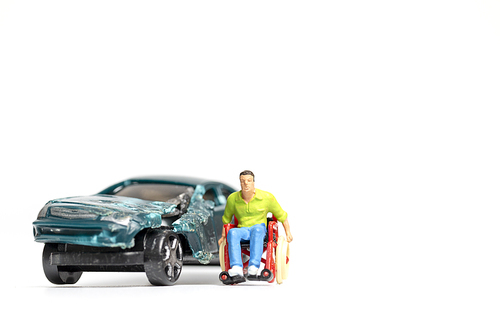 Miniature people : Man on wheelchair and car wreck , Don't drink and drive concept.