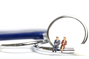 Miniature people sitting on a stethoscope on white background , Health care  concept