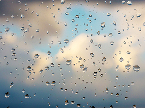 Water drops of rain on blue glass background. Rain drops on window