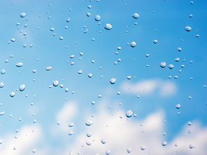 Water drops of rain on blue glass background. Rain drops on window