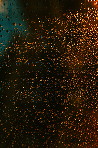 A background of a colorful crystal with water drops in it, on red and green tones