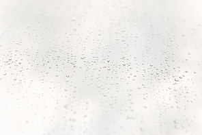 A minimalistic and clean background with water drops over a crystal clear white