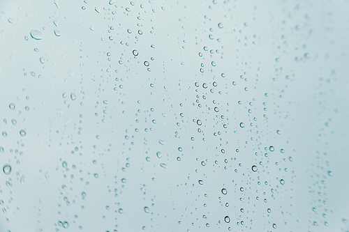 An horizontal background of some rain drops over a crystal surface