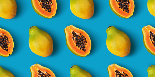 Papaya fruit seamless pattern on blue color background, flat lay, top view