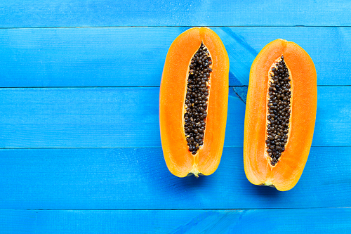 Papaya fruit on blue wooden background
