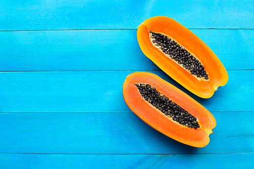 Papaya fruit on blue wooden background