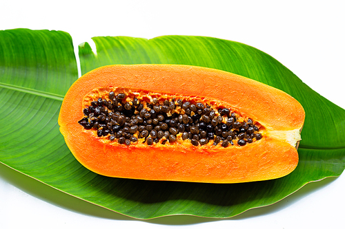 Sweet ripe papaya on tropical banana leaves.