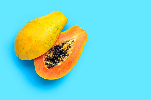 Papaya fruit on blue background. Top view