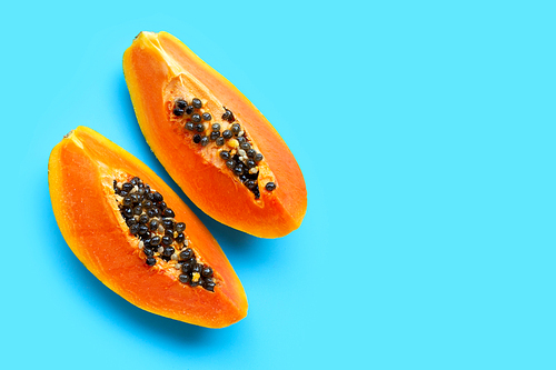 Papaya fruit on blue background. Top view