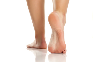 female bare feet on white background