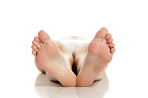 female bare feet on white background