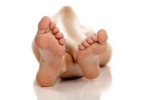 female bare feet on white background