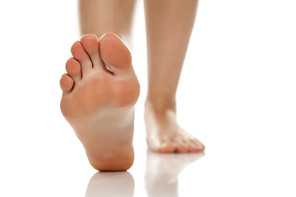 female bare feet on white background