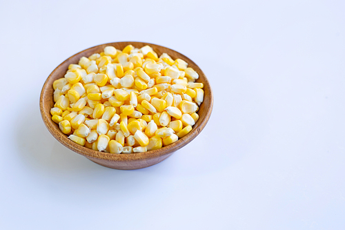 Corn seeds  wooden bowl on white background