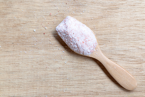 Pink salt , Himalayan salt on wooden background