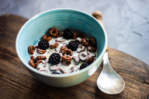 Traditional breakfast with chocolate cornflakes, yogurt and honey on rustic background