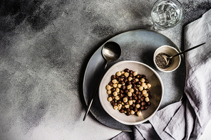 Bowl with cereals balls and chia seeds served on concrete background