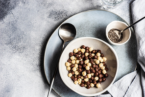 Bowl with cereals balls and chia seeds served on concrete background