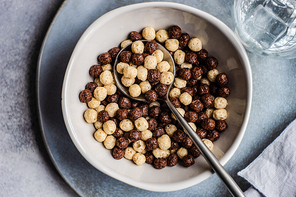 Bowl with cereals balls and chia seeds served on concrete background