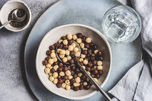 Bowl with cereals balls and chia seeds served on concrete background