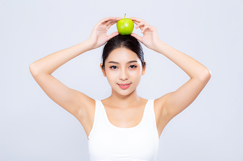 Beautiful portrait asian woman smiling holding green apple fruit and body diet with fit isolated on white, girl weight slim with cellulite or calories, health and wellness concept.