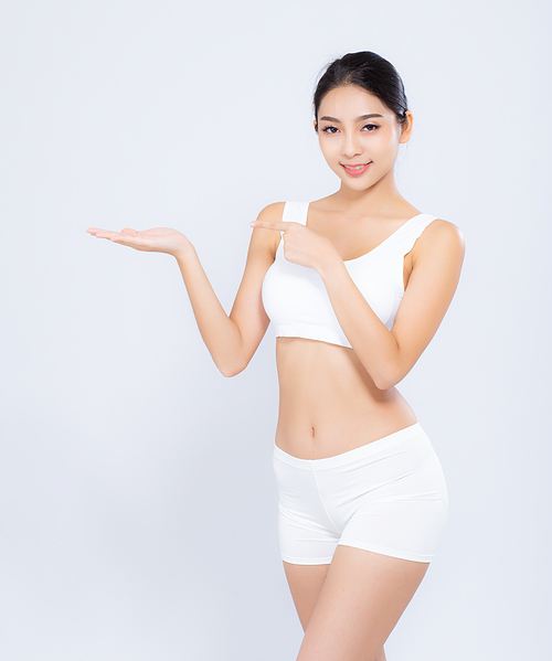 Portrait young asian woman smiling beautiful body diet with fit presenting something copy space on the hand isolated on white, model girl weight slim with cellulite or calories, health and wellness concept.