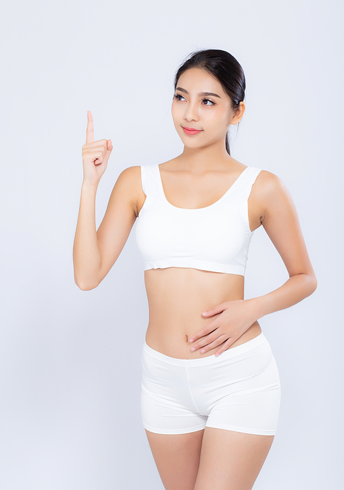 Portrait young asian woman smiling beautiful body diet with fit and finger pointing something isolated on white, model girl weight slim with cellulite or calories, health and wellness concept.