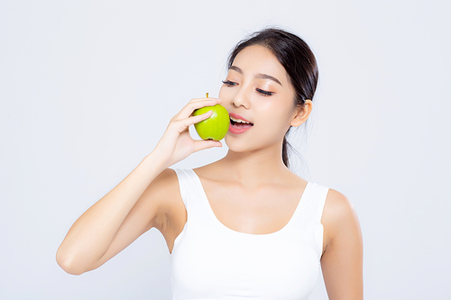 Portrait asian woman smiling holding and eating green apple fruit and beautiful body diet with fit isolated on white, girl weight slim with cellulite or calories, health and wellness concept.