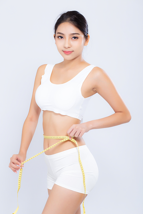 beautiful portrait asian woman diet and slim with measuring waist for weight isolated on white, girl have cellulite and calories loss with tape measure, health and wellness concept.