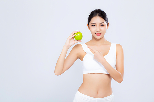 Portrait asian woman smiling holding green apple fruit and beautiful body diet with fit isolated on white, girl loss weight slim with cellulite or calories, health and wellness concept.