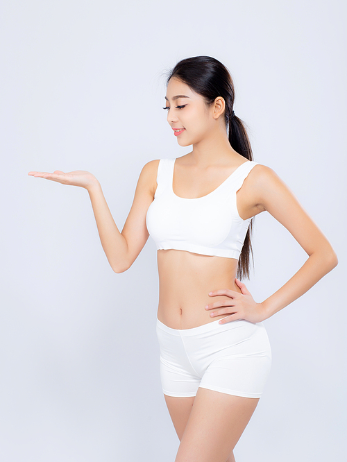 Portrait young asian woman smiling beautiful body diet with fit presenting something empty copy space on the hand isolated on white, model girl weight slim with cellulite or calories, health and wellness concept.