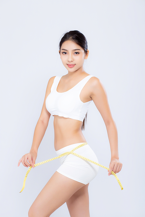 beautiful portrait asian woman diet and slim with measuring waist for weight isolated on white, girl have cellulite and calories loss with tape measure, health and wellness concept.