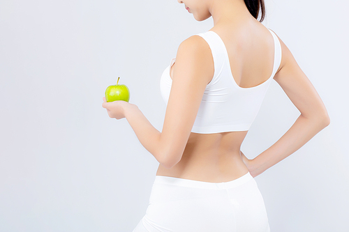 Back view portrait asian woman holding green apple fruit and beautiful body diet with fit isolated on white, girl weight slim with cellulite or calories, health and wellness concept.